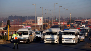A traffic controller gestures in front of minibus taxis as they transport commuters to work, in Soweto, Johannesburg, South Africa June 15, 2017. (Reuters)