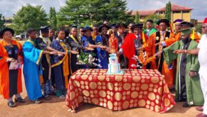 Management with some of the matriculating students cutting the cake