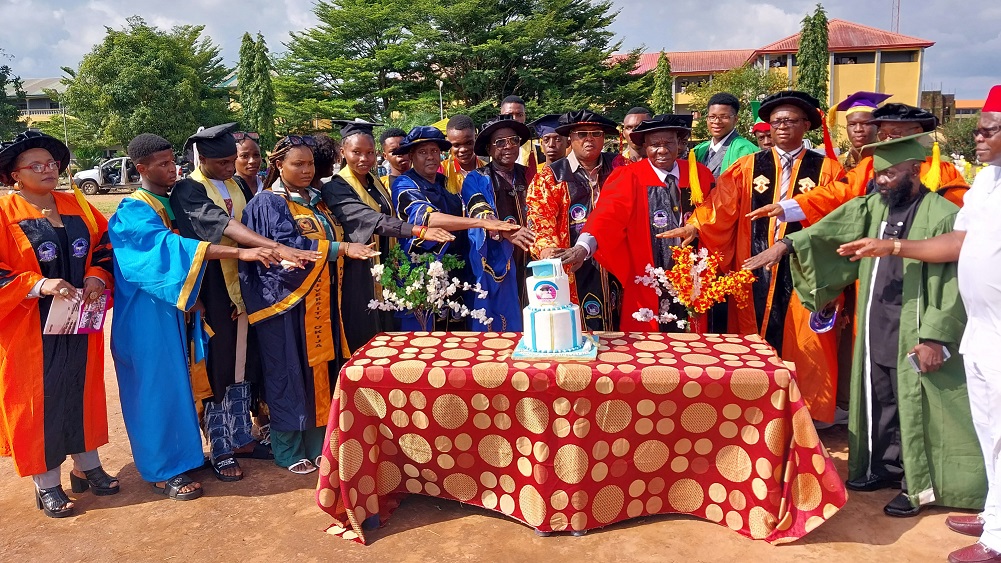 Management with some of the matriculating students cutting the cake