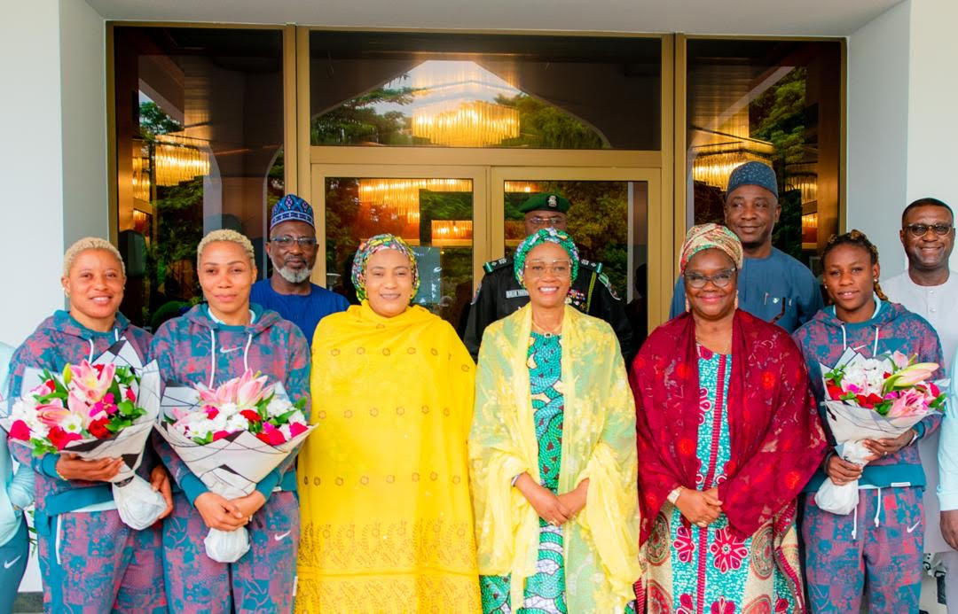 First Lady of Nigeria, Oluremi Tinubu, (m) flanked on the right by Wife of the Vice President, Hajia Nana Shettima (3rd left), Wife of the Senate President, Mrs Ekaette Akpabio (2nd right), Super Falcon players and other officials of the NFF, during their reception by her Excellency, in Abuja