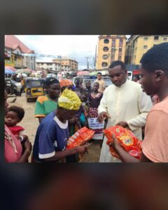 Fr George distributing the materials to the destitutes