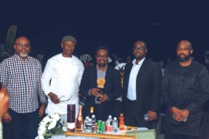 Uwaibi flanked by friends and well wishers shortly after receiving the award in Benin City