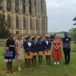 The visiting students and their priest manager with the hosts