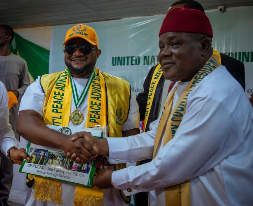 DR VICTOR EKPENYONG, (LEFT) CEO KENYON INTERNATIONAL, RECEIVING THE LAURELS FROM REPRESENTATIVE OF UN POLAC, AMB. PETET OHAGWA, DEPUTY COUNTRY PRESIDENT UN POLAC