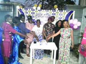 The old boys and girls cutting the anniversary cake copy
