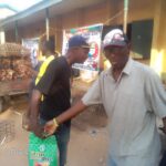 Handing rice to the benegiciaries