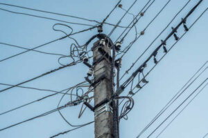 165657537-the-old-concrete-electric-support-is-chaotically-hung-with-many-wires-close-up