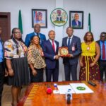Enugu Governor Peter Obi (centre left) presented with a plaque by Emeka Eleh of estate surveyor group Ubosi Eleh and Co on Wednesday, June 26, 2024, at Government House, Enugu