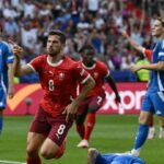 Switzerland beat holders Italy to reach quarter-finals