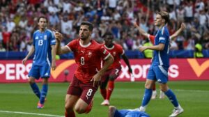 Switzerland beat holders Italy to reach quarter-finals