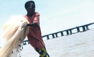 Topozhim-casting-his-fishing-net-into-the-water-in-the-hope-of-making-a-good-catch