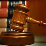 Judges gavel and law books stacked behind