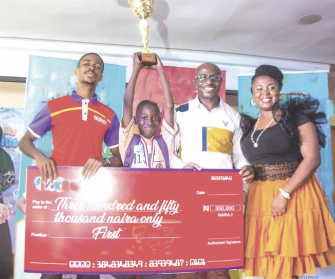 •L-R- Chika Onwuatuogu, a judge; Aderibigbe Emmanuel, the winner; Emeka Onyejiaka, and Catherine Onyejiaka, both judges, at the presentation of mock cheque and trophy to Emmanuel