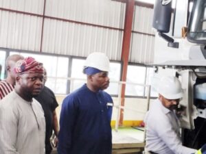 •MD of LSM, Taiwo Shittu (left) taking the NADDC DG, Joseph Osanipin, through the assembly line