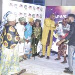 Chikwem distributing bags of rice to guests and members of his church