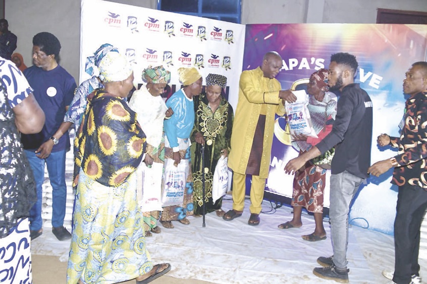 Chikwem distributing bags of rice to guests and members of his church