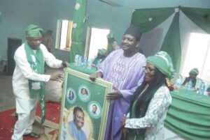 Presentation of souvenir to Adesina (middle)