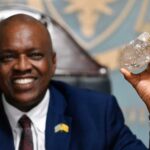 Bostswana President Mokgweetsi Masisi holds the large diamond at his office in Gaborone, August 22, 2024
