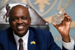 Bostswana President Mokgweetsi Masisi holds the large diamond at his office in Gaborone, August 22, 2024