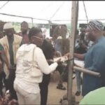 •Salawu presenting palliative to one of the beneficiaries