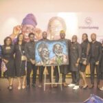Francis Jide (fifth from left) with team members of VisionSpring in a group photograph, where he displayed the artwork he drew at the venue