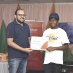 Umer Hayat, general manager, animal feed segment, Olam Agri (right), presenting a Back-to-School scholarship award certificate to Obi Amarachukwu, a beneficiary of the initiative, recently, in Ilorin.