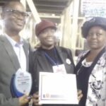 •Bolaji (m) flanked by her parents