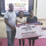 Michelle flanked by her teachers