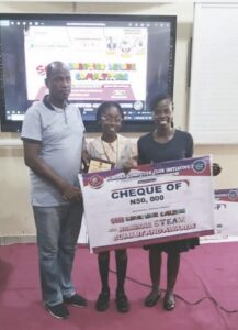 Michelle flanked by her teachers