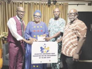 Mrs. AbdulKarim-Yusuf (middle) presenting the cheque at the event