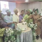 •Fadipe surrounded by guests during the cutting of the anniversary cake.