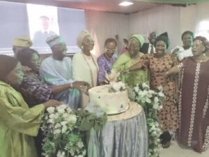 •Fadipe surrounded by guests during the cutting of the anniversary cake.