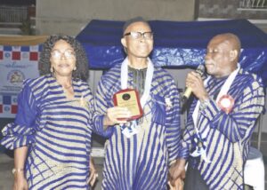 •Sir Steve Osuji receiving his Leading Light Award from Mr. Placid Eziefule, president, ICU, Lagos. With him is his wife, Uchenna Osuji.