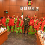 Chief of Army Staff (COAS) Lieutenant General Olufemi Oluyede surrounded by NAOWA members