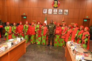 Chief of Army Staff (COAS) Lieutenant General Olufemi Oluyede surrounded by NAOWA members