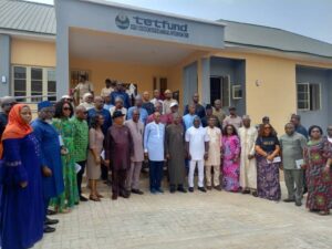 Group photograph outdoors in front of TetFund office