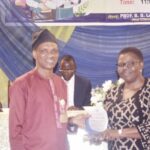 Deputy VC (Academic), Dr. Morufu Daodu (left) presenting award to Prof. Ogunyemi