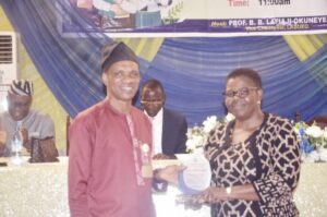 Deputy VC (Academic), Dr. Morufu Daodu (left) presenting award to Prof. Ogunyemi