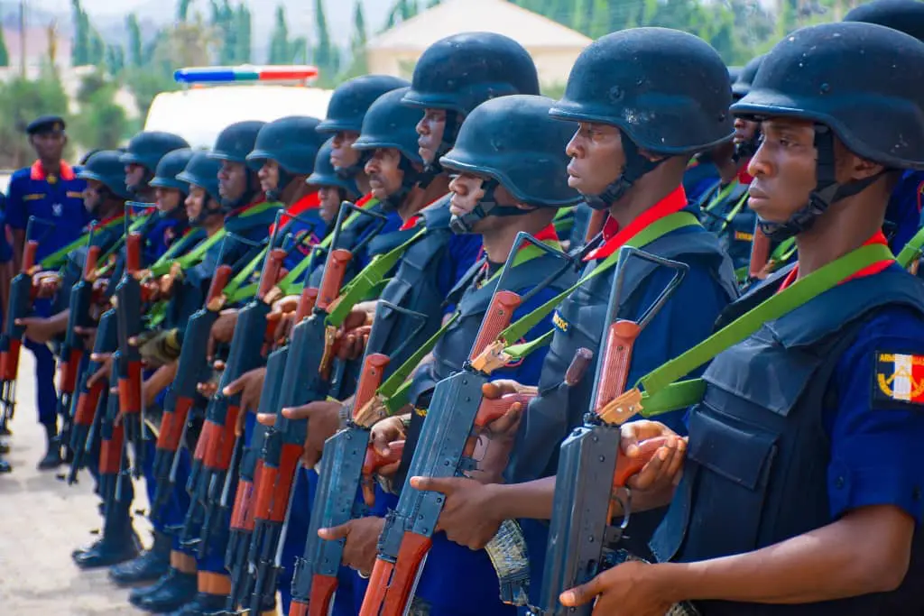 NSCDC officers on parage, holding rifles