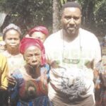 Nweke (middle) with adopted mother (3rd left) and others