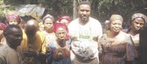 Nweke (middle) with adopted mother (3rd left) and others