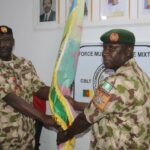 Maj Gen Godwin Mutkut receives the MNJTF flag from his predecessor, Maj Gen Ibrahim Ali, during the handing-over ceremony on Thursday, January 23, 2025