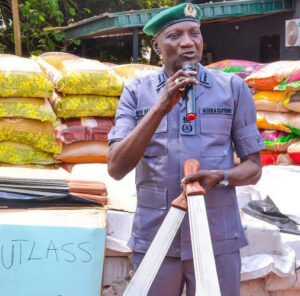 The Customs Area Controller of Ogun 1 Area Command, Mohammed Shuaib, displaying cutlasses and smuggled items to newsmen
