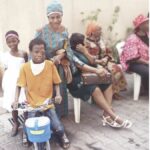 A boy receives a bicycle as gift from CLCWF Christmas party