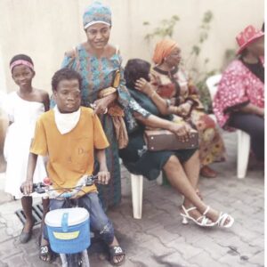A boy receives a bicycle as gift from CLCWF Christmas party