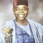 Ebuh displaying the Distinctive Leadership Award