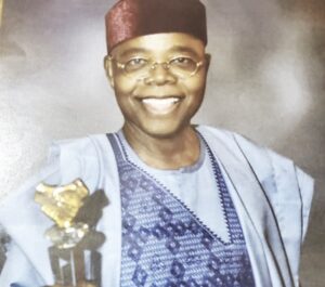 Ebuh displaying the Distinctive Leadership Award