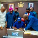 Governor-Monday-Okpebholo-signing-1024×683