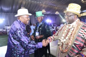 Iyaye (left), in a handshake with Opuiyo (right), during a stakeholder’s interactive forum on the Borikiri-Okrika Bridge project. With them is King Frank (right)