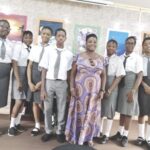 Oluchi Benedict, art teacher, Laureates College, flanked by some of the student exhibitors